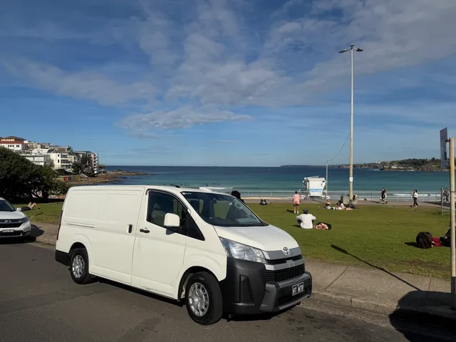 The parked Bondi Hot Water van in front of a bondi beach