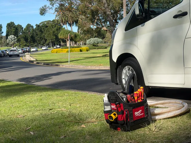 Tools on the ground near the parked Bondi Hot Water van